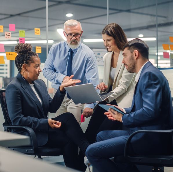 Office workers gathered around in a meeting room